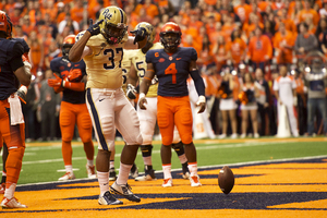 Pittsburgh running back Qadree Ollison celebrates a touchdown as SU linebacker Zaire Franklin looks on. 