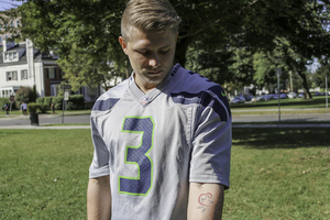 Junior Konstantin Hicker got a tattoo of his adoption agency's logo to honor their help in getting him adopted. 