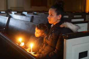Monira Alozaime, who works at the District Attorney’s office, and her son attend a candlelight vigil honoring children whose lives were taken away by abuse, neglect and crime at Hendricks Chapel on Tuesday. 